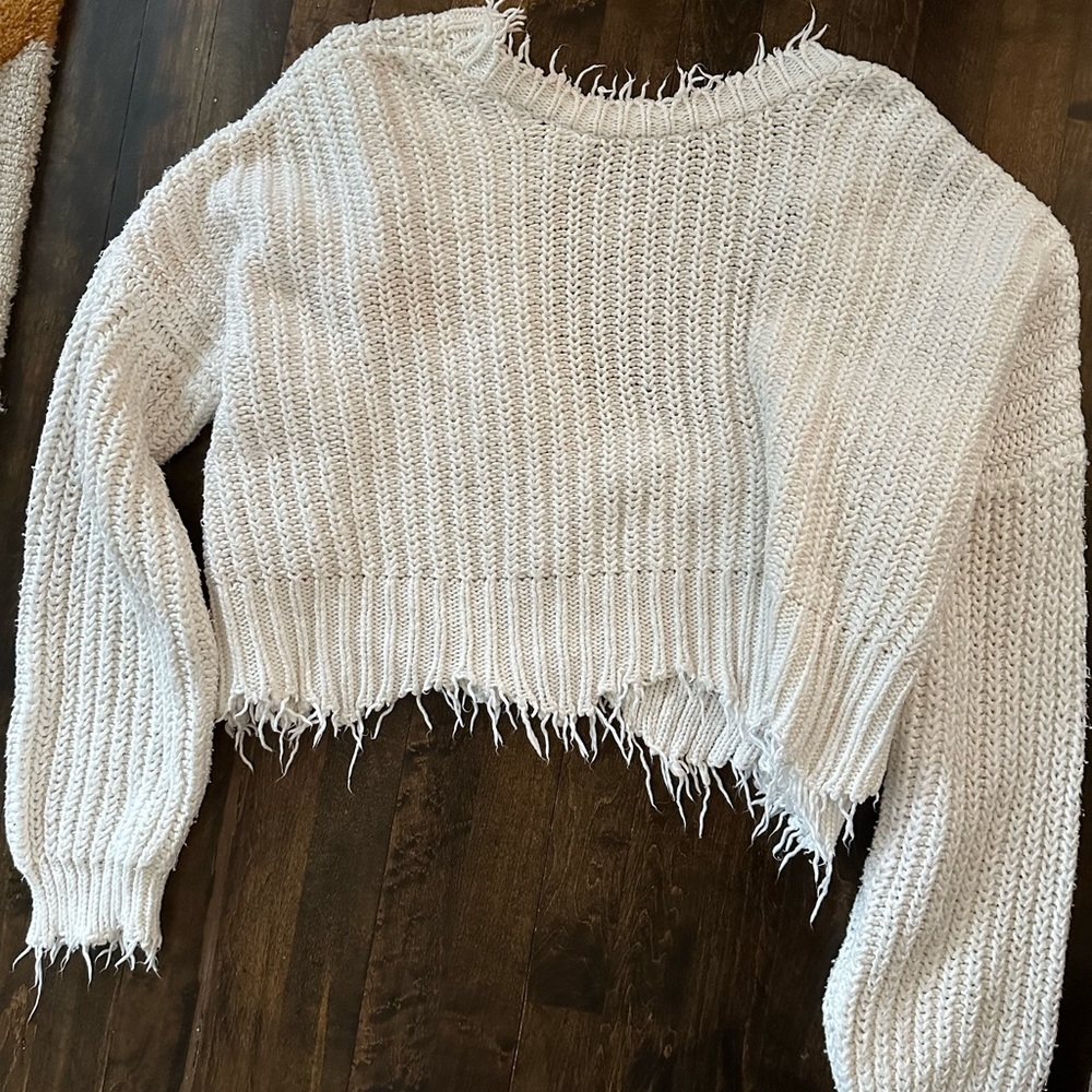 White sweater with frayed details